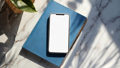 mobile telephone empty display mock up blue notebook on white marble table with natural abstract sun light shadows background aesthetic business brand template