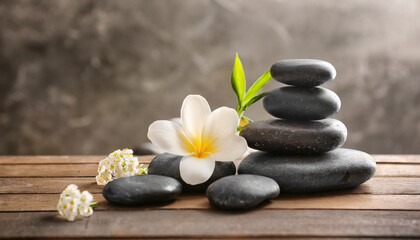 Fototapeta na wymiar spa stones and white flower on table