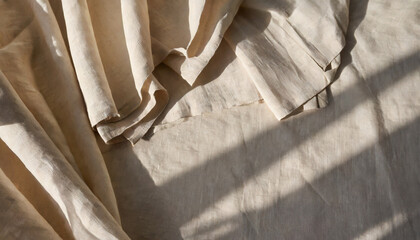 draped beige linen fabric texture background with natural sunlight shadows neutral lifestyle...