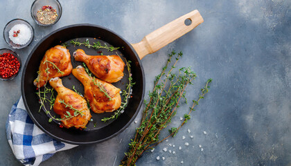 grilled chicken thighs in a frying pan with fresh thyme view from above flatlay empty space