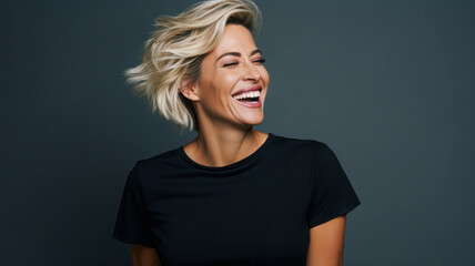 Beautiful smiling woman with short hair in studio shot on gray background.