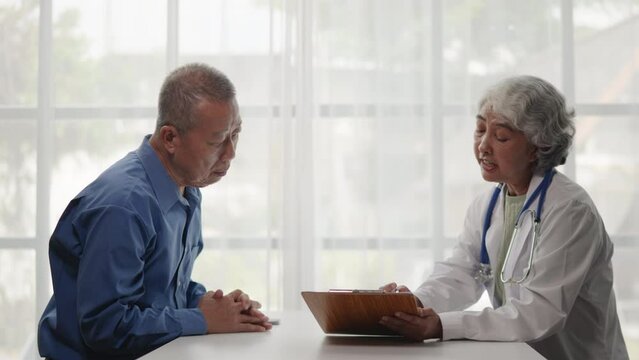 The doctor takes interview the old man patient's history and symptoms and advice treatment method.