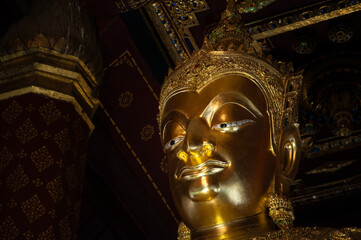 Close of golden buddha image of Wat Na Phra Men with space on right