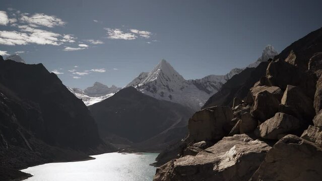 beautiful turquoise water of the lake at laguna paron lagoon in the high andes mountains of the cordillera blanca at huascaran, Peru, with snow covered mountain peaks on a bright sunny day.