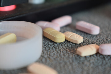 medical pill and bottle with mug or glas of water on table workspace