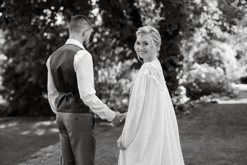 Fototapeta na wymiar wedding walk of the bride and groom in a coniferous in elven accessories