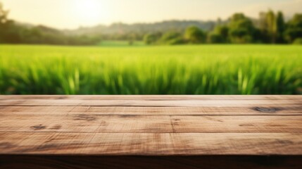 Empty wooden table top with a background of green rice fields Out-of-focus bokeh Templates for displaying products