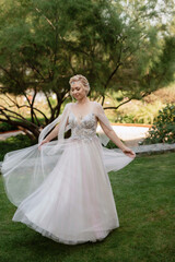 Fototapeta premium portrait of a happy bride in a light light dress in wearing elven accessories