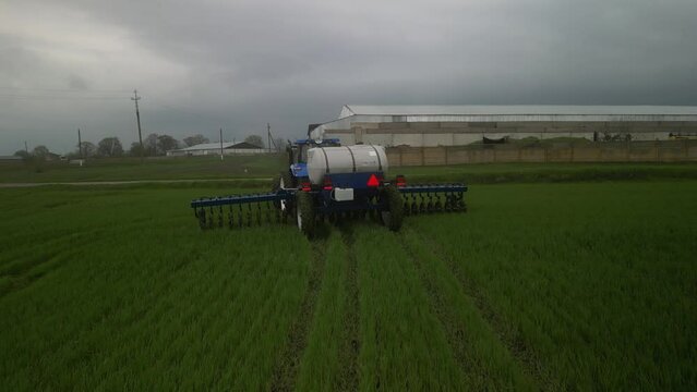 Tactor on the field doing liquid fertilizer injection