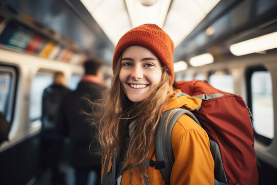 smiling woman with backpack traveling by train
