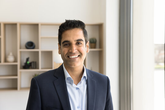 Happy Handsome Indian Businessman In Formal Suit Looking At Camera With Toothy Smile. Positive Top Manager, Executive, CEO, Entrepreneur, Business Professional Head Shot Portrait