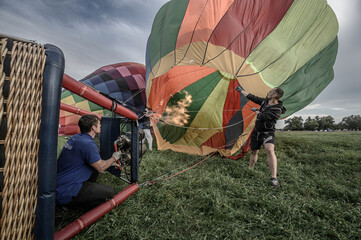 People inflate a balloon with fire