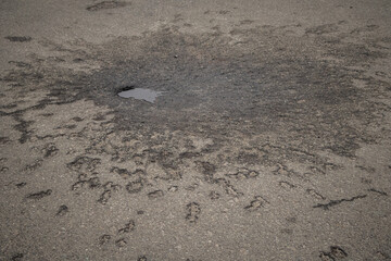 a hole in the pavement from the arrival of a projectile