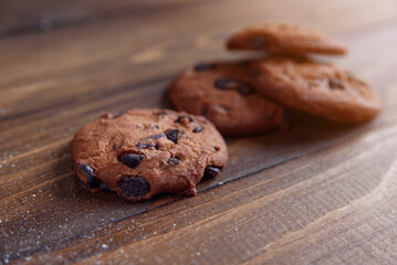 Shortbread cookies with chocolate chips on wooden background. Fresh pastry.
