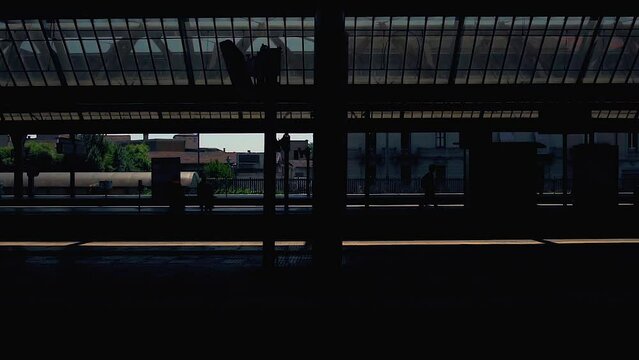 Vision from the window of a train moving towards the station, cinematic images, evocative colours