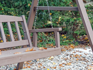 Swinging bench in the fall