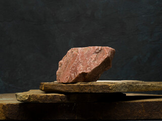 stones on a dark gray background for the podium. stones with texture for product presentation. minimalist background with stones for the podium.