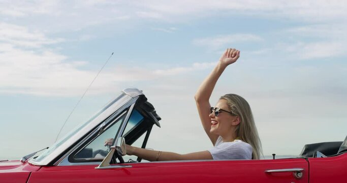 Freedom, driving and woman in a car for road trip, vacation or weekend holiday in the coast. Transport, adventure and young female person from Australia with sunglasses riding a new luxury vehicle.