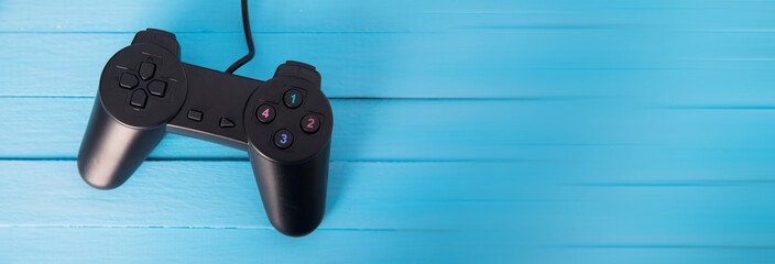 Video games controller on wood background