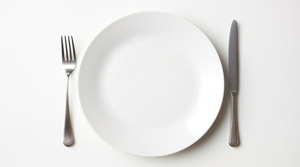 Empty white plate with fork and knife on white background, top view
