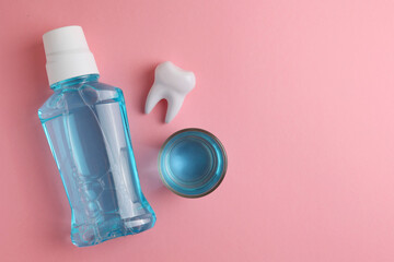 A mouthwash on a colored background. Dental care, dental health. - obrazy, fototapety, plakaty