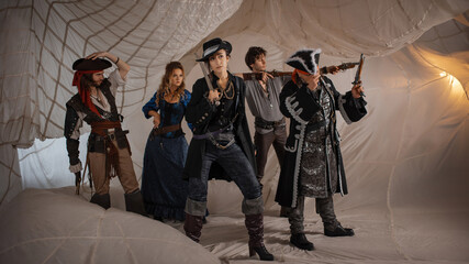 A merry band of pirates, a group photo in carnival costumes, corsairs on the background of sails