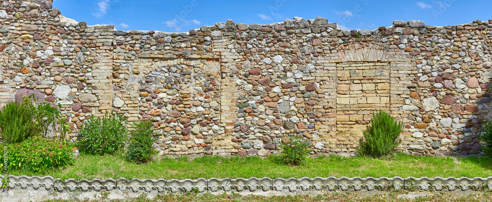 Wall mural rustic castle wall in tuscany, italy, in panoramic format.