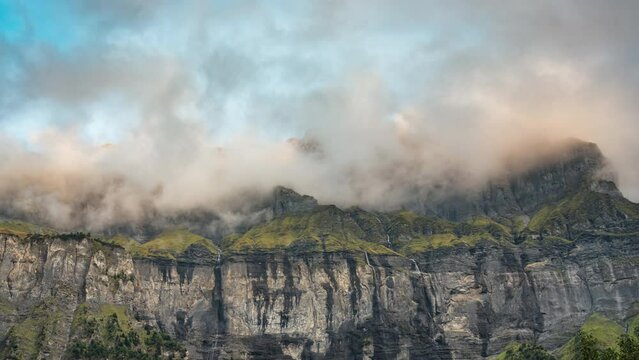 Landscape of Giffre valley of mountain range with cascade and foggy in the evening at Sixt Fer a Cheval, French Alps, France