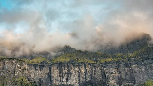 Landscape of Giffre valley of mountain range with cascade and foggy in the evening at Sixt Fer a Cheval, French Alps, France