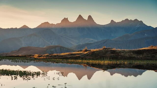 Landscape of sunrise shines over Lac Guichard with Arves massif and lake reflection in autumn at Aiguilles d Arves, French Alps, Savoie, France