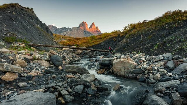 Landscape of iconic three peak mountain and waterfall flowing in the valley of Aiguilles d Arves in French alps on autumn at Savoie, France