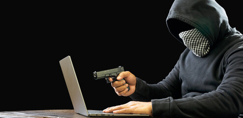 Portrait hacker spy man one person in black hoodie sitting on table looking computer laptop used password attack security intimidate to circulate data digital  internet network system dark background - obrazy, fototapety, plakaty