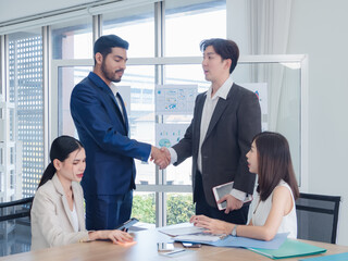 Portrait business team woman pretty girl cute and man handsome smart Asian group standing on wall white looking shake hand within the agreement ready for happy working online sale inside home office