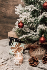 Fototapeta na wymiar Christmas tree with gifts and candle. Christmas tree on the table