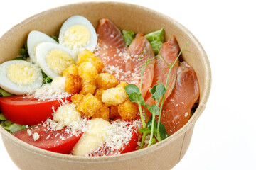 Caesar salad with salmon on a white background for a food delivery site 2