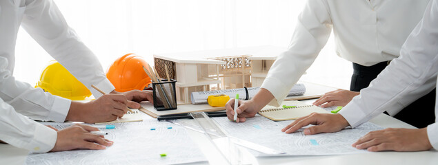 Worker, architect and engineer work on real estate construction project oratory planning with...