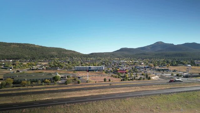 Aerial above Interstate 40 through Williams Arizona on autumn day