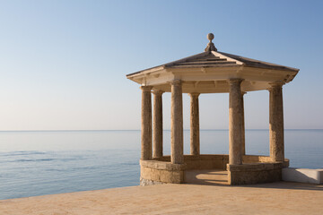 Stone gazebo facing the sea and blue sky