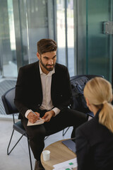 Business partners have meeting in cafe to solve biz issues and work with documets