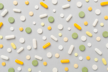 Flat lay with different medical pills and capsules on color background