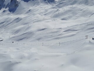 Ski resort on a clear Sunny day. Snow on the Zugspitze mountain height -2962 m. in Bavaria, Germany - obrazy, fototapety, plakaty