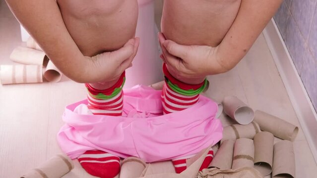 woman sitting on toilet with toilet paper and suffering from constipation, diarrhea, stomach ache or cramps, Hygiene, health care concept, constipation in menopause