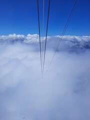 The mountains are hidden by a thick white cloud, a view from inside the cab of the cable car on the Zugspitze mountain height -2962 m. in Bavaria, Germany