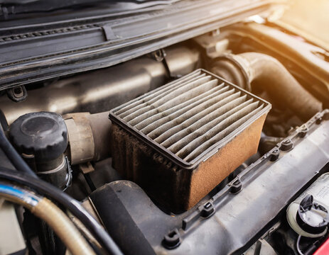 Dirty air filter on vehicle engine. Automotive repair, maintenance, service and fuel mileage concept