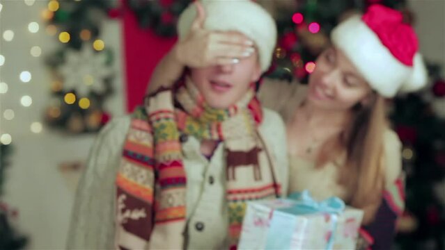 Young beautiful couple giving presents to each other