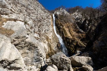 Fototapeta na wymiar Gregorcicev Slap 100 meters high Waterfall in Alpine Environment under mount Krn in Julian Alps Slovenia