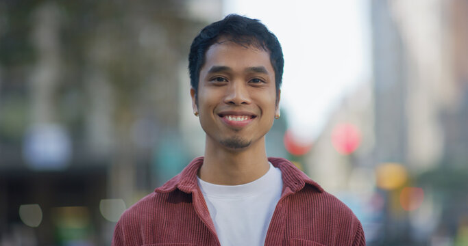 Young Filipino man smile face portrait on city street