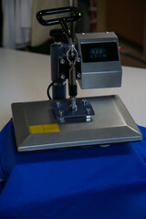 Fototapeta premium Printing logo. Heat press with t-shirt on white table
