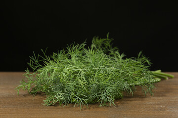 Fresh green dill on wooden table, closeup