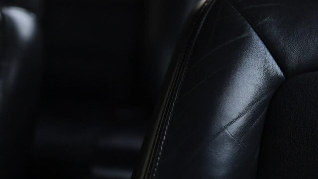 luxury black leather seats in the interior of a business car close-up.